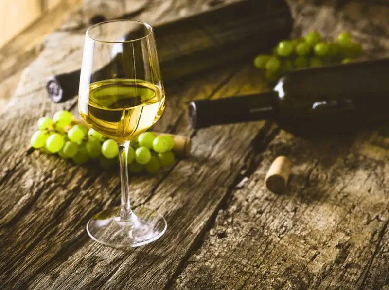 Portuguese white wine glass with grapes on rustic table