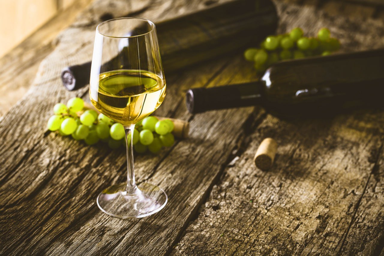 Portuguese wine guide image with grapes and white wine glass